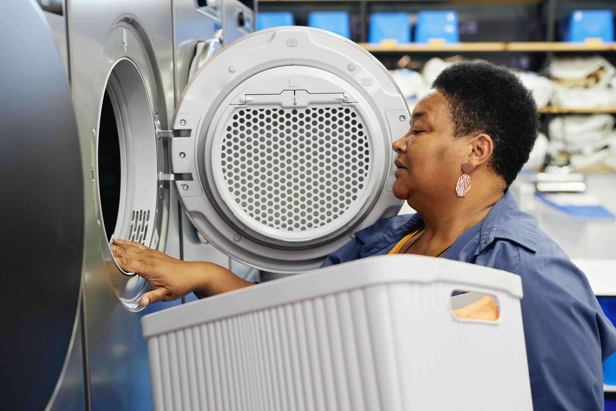 lady organising through laundry in washing machine