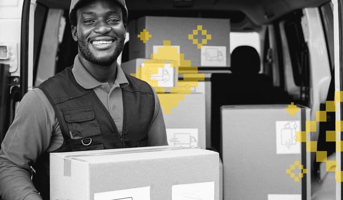 delivery man holding a box smiling